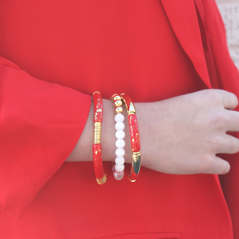 This 3-piece red beaded stretch bracelet set is the perfect statement piece. With its bold and bright colors, this bracelet set is designed with 18K gold filled beads, white crackled beads, and red and gold acrylic bangles.
