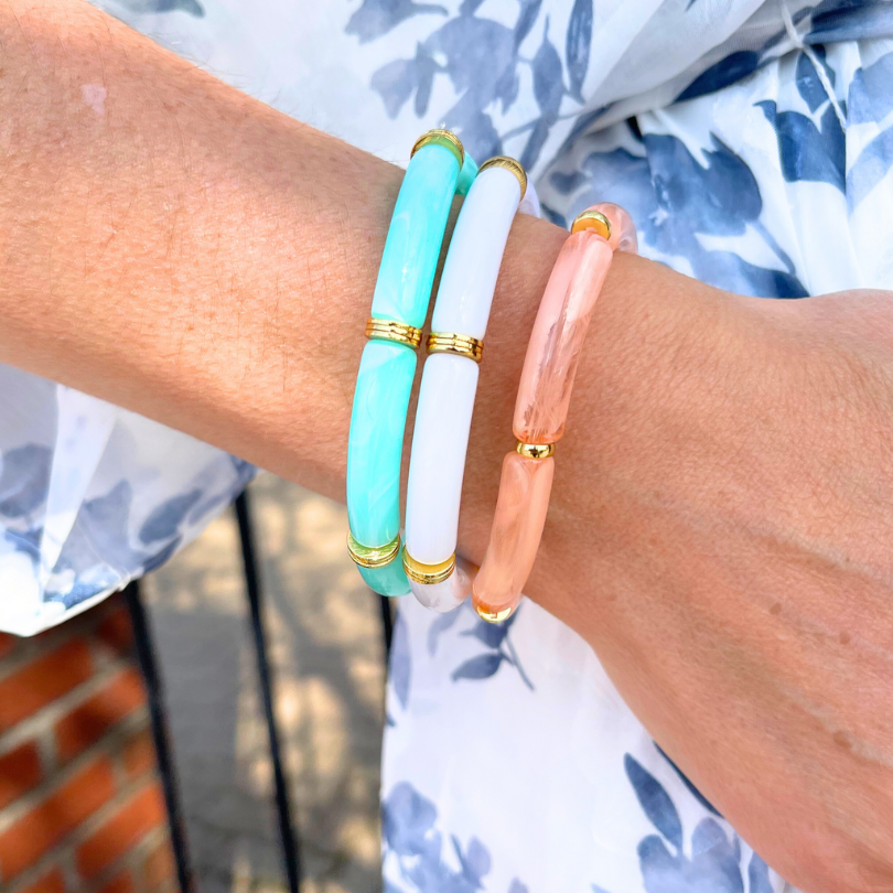 Model wearing 3-piece 8mm acrylic bracelet set.