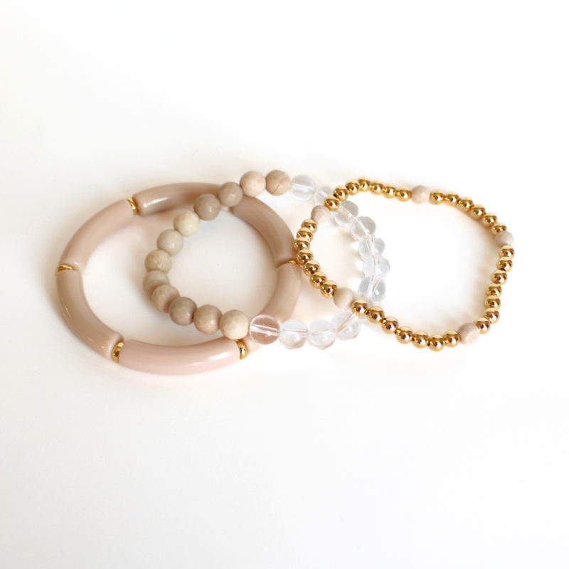 Neutral gold- filled beaded bracelet set that will go with any or all of your bracelets in your jewelry box. Curated with cream river stone beads, cream acrylic bangle, clear quarts and gold-filled round beads. This bracelet can be worn with a casual day outfit or night out by adding one of our bright beaded bracelets.