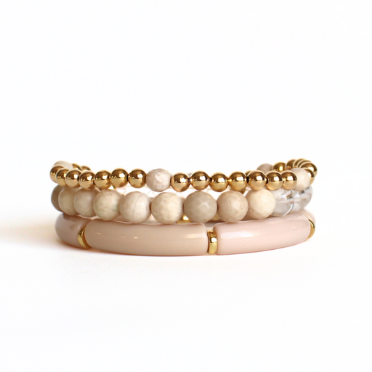 Neutral gold- filled beaded bracelet set that will go with any or all of your bracelets in your jewelry box. Curated with cream river stone beads, cream acrylic bangle, clear quarts and gold-filled round beads. This bracelet can be worn with a casual day outfit or night out by adding one of our bright beaded bracelets.