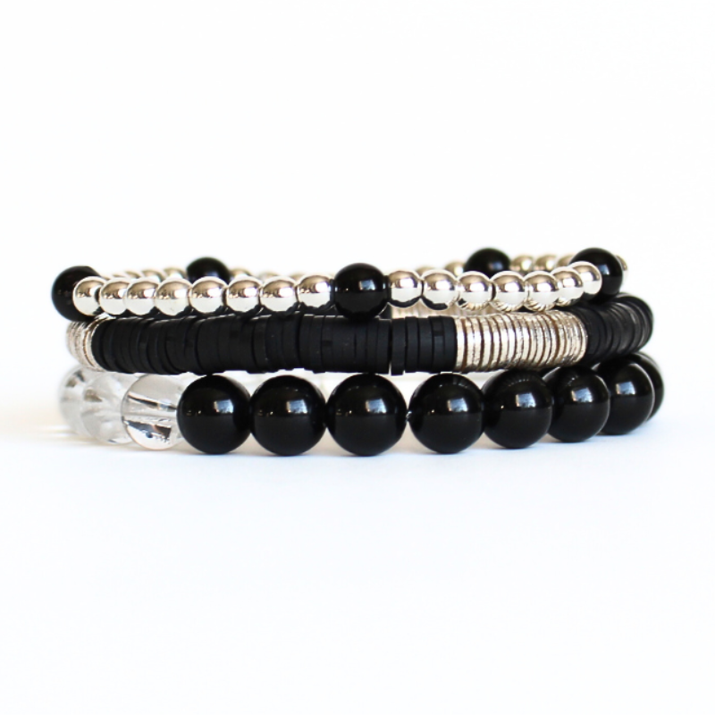 Black and silver beaded bracelet set curated with silver round beads, black onyz gemstones, clear quartz gemstone and black polymer clay beads.