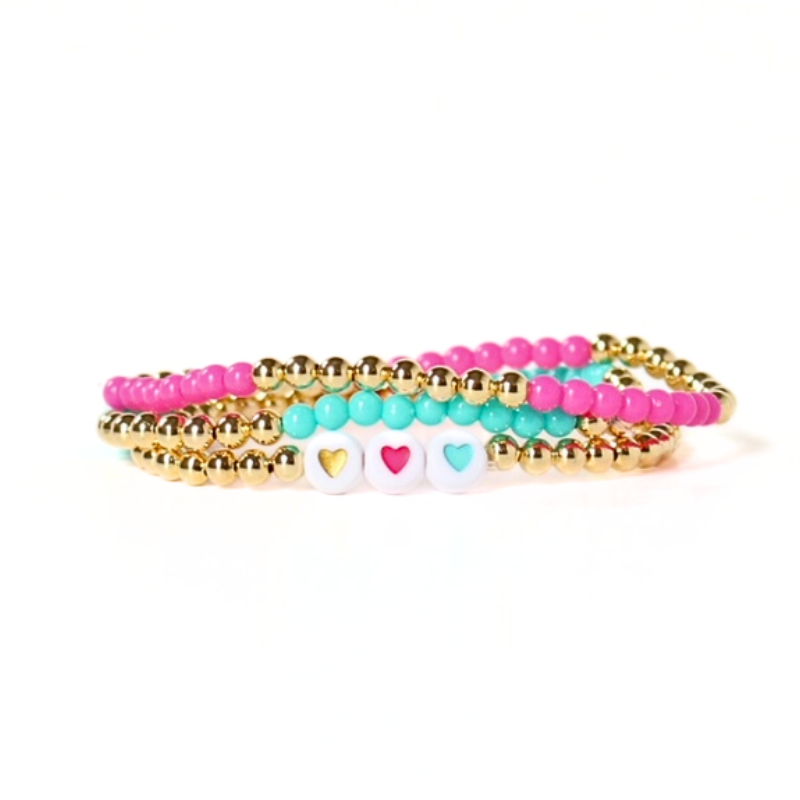 This dainty 3-piece stretch bracelet stack is designed with 4mm 18k gold filled round beads. 3 bracelets are adorned with 4mm acrylic beads: orange, pink and blue. White acrylic beads with colored heart centers accent one bracelet.