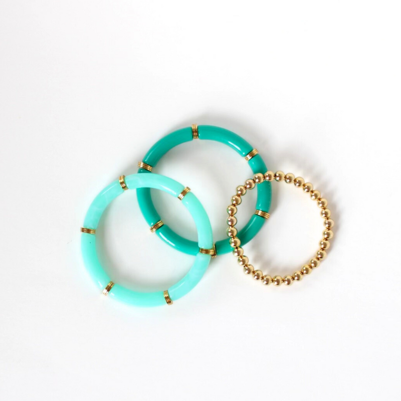 Bracelet stack with 3 bracelets. Two bracelets are acrylic tube beaded bangle bracelets with gold plated flats. The dainty gold filled beaded stretch bracelet adds that extra sparkle.