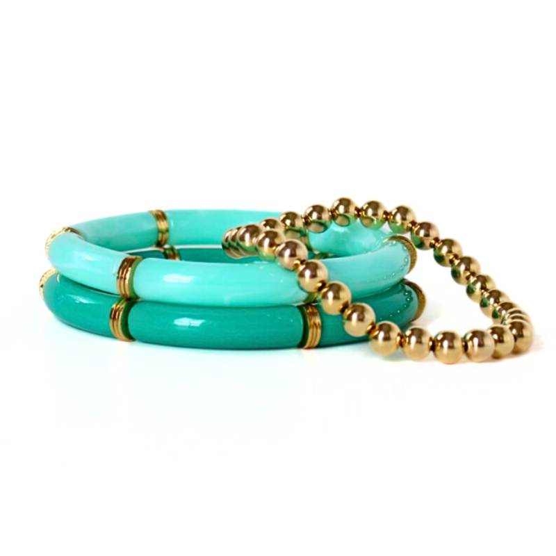 Bracelet stack with 3 bracelets. Two bracelets are acrylic tube beaded bangle bracelets with gold plated flats. The dainty gold filled beaded stretch bracelet adds that extra sparkle.