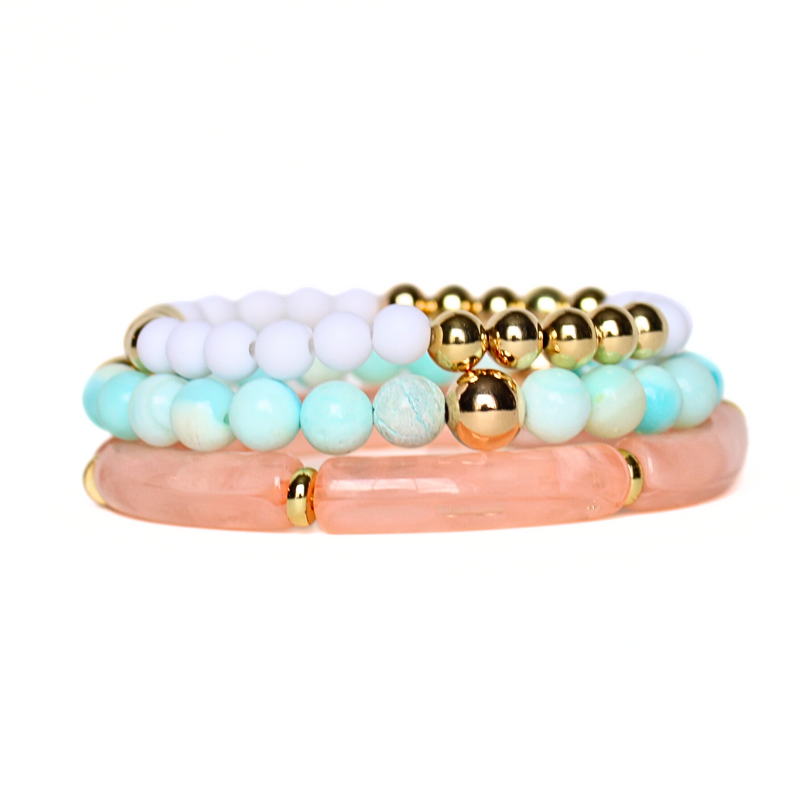 3-peice beach inspired stack. Designed with peach marble 8mm skinny acrylic bamboo tubes with gold plated flats. This stack also is designed with 8mm blue opal beaded bracelet with gold filled beads and a 5mm gold filled beaded bracelet accented with white round acrylic beads.
