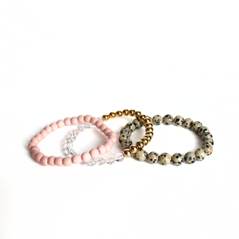 This neutral warm 3-peice set has soft features that go with any outfit. Curated with pink round wooden beads, gold filled beads, clear quartz beads and jasper gemstone beads.