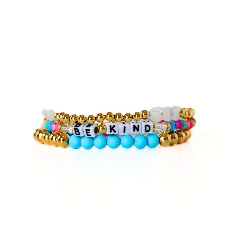 3-piece rainbow beaded letter beaded bracelet set designed with gold-filled beads, blue acrylic beads and mother of pearl heart charms