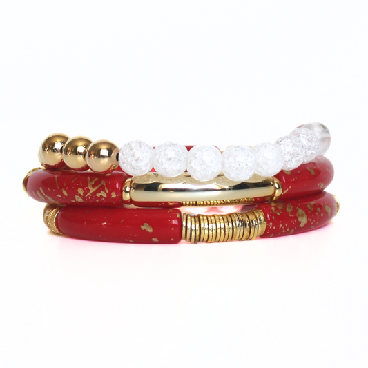 This 3-piece red beaded stretch bracelet set is the perfect statement piece. With its bold and bright colors, this bracelet set is designed with 18K gold filled beads, white crackled beads, and red and gold acrylic bangles.