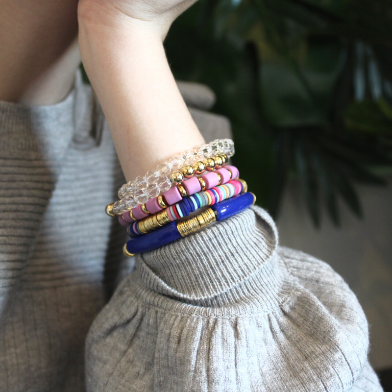 5-piece blue and purple beaded bracelet stack. Designed with royal blue acrylic tube bangle bracelet, purple wide polymer clay beads, gold-filled beaded bracelet with clear glass beads.