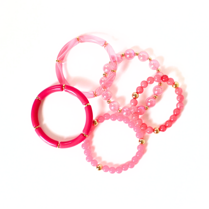 5-piece barbie pink chunky beaded bracelet stack. Designed with pink acrylic bangles, 12mm pink iridescent beads, and gold filled round beads.