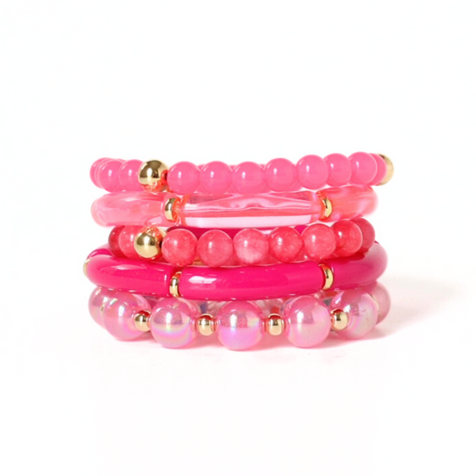 5-piece barbie pink chunky beaded bracelet stack. Designed with pink acrylic bangles, 12mm pink iridescent beads, and gold filled round beads.