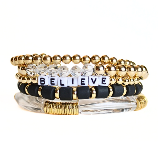 Feel and look glamorous in this 5-Piece 18K gold beaded stretch bracelet set black polymer clay beads. Clear acrylic bangle and white acrylic cubed letter bead which are personalizable.