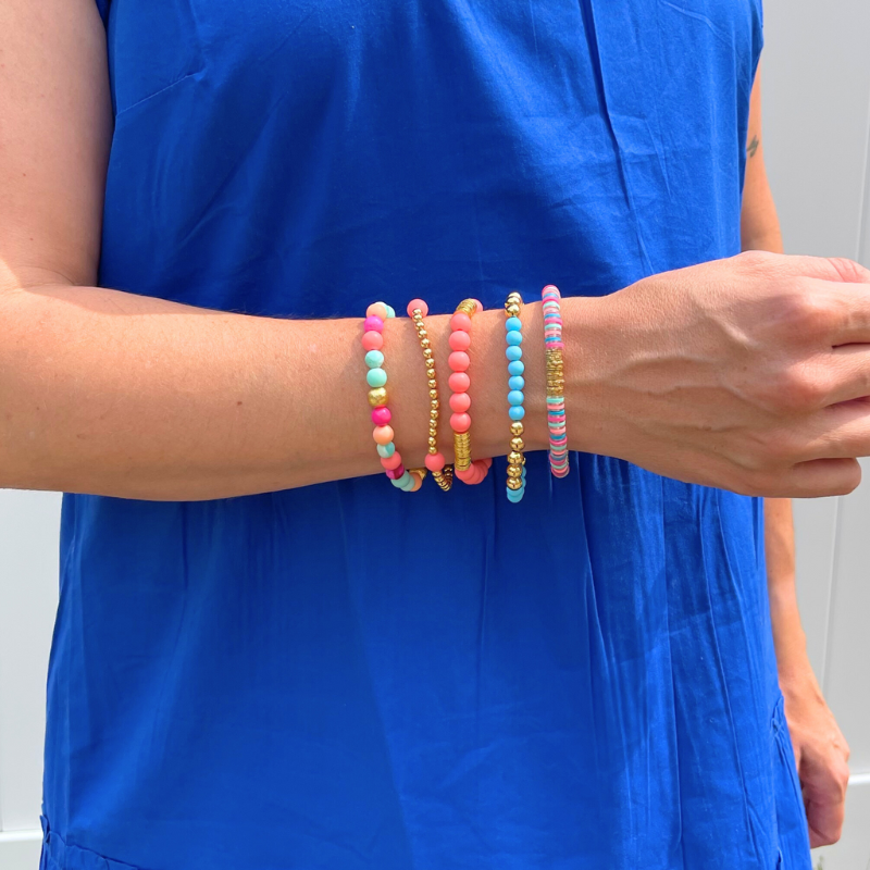 Bracelet stack with 5 beaded stretch bracelets. The Key West bracelet stack is designed with blue and watermelon acrylic beads and polymer clay beads. This bracelet stack is adorned with pink and blue opal gemstones. 18K gold filled beads add long lasting sparkle to this stack.