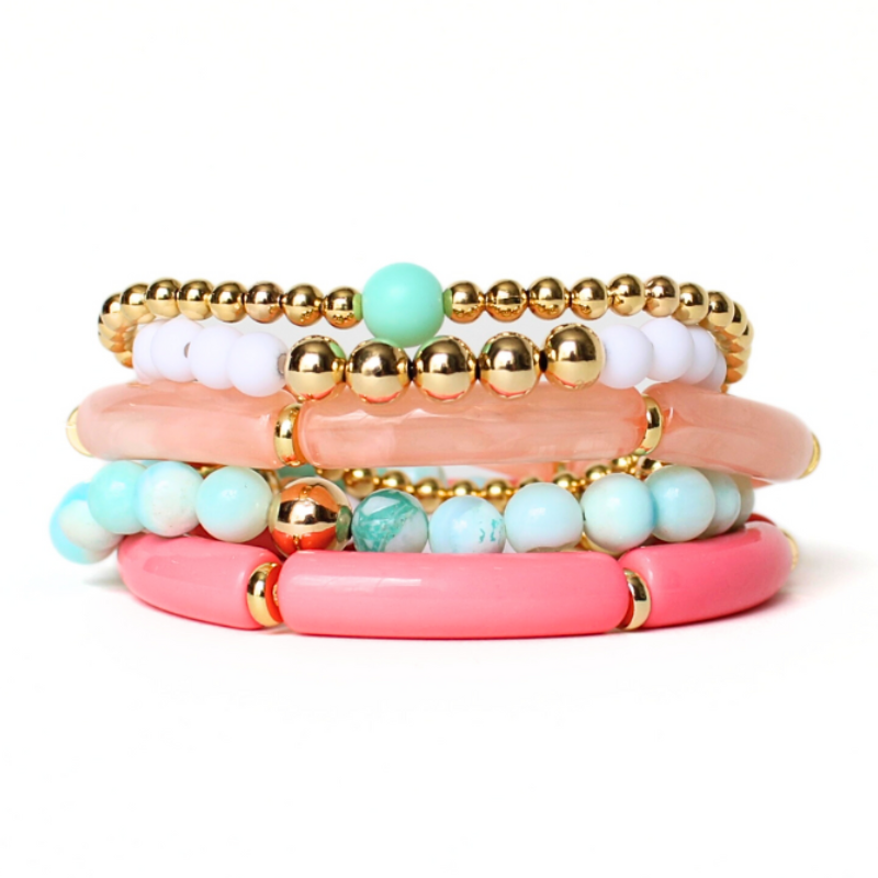 5-peice beach inspired stack. Designed with blue opal gemstone beads with gold filled round beads. Two acrylic 8mm skinny tube bangles with gold plated flats. Acrylic tubes are peach marble and watermelon. The other two bracelets in this set are dainty and are adorned with gold filled round beads. 6mm blue acrylic beads and 5mm white acrylic beads accent the gold bracelets.