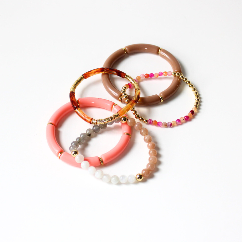 5-piece bracelet stack is designed with coral and brown acrylic bangles. This bracelet stack has a stunning beaded bracelet with chakra, moonstone and sunstone beads. These beads are healing stones and go perfectly with the dainty coral and gold-filled beaded bracelet.
