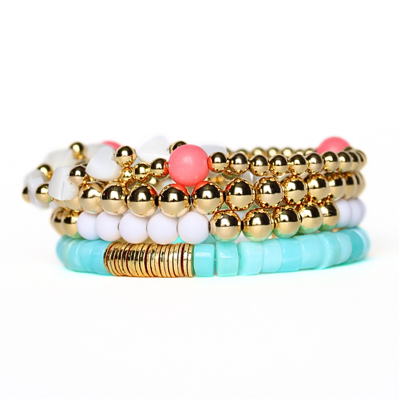 5-piece blue opal heishi gemstone bracelet stack with gold-filled beaded bracelets. Designed with mother of pearl heart bracelet with gold-filled beads.