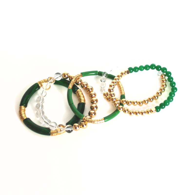 Green acrylic and gemstone beaded bracelet set with gold beads.