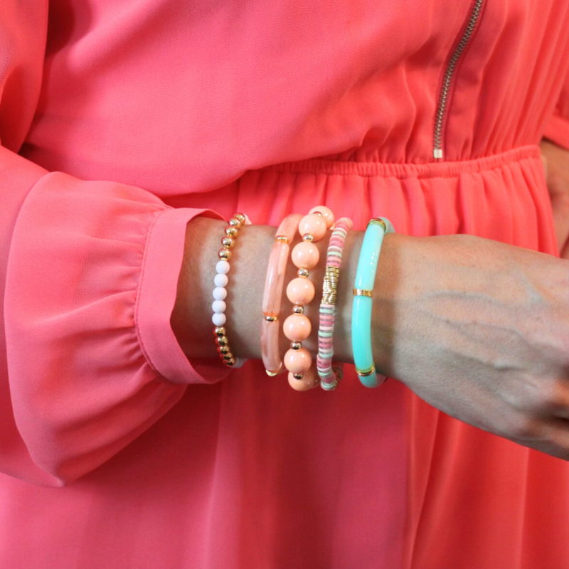5-Peice bracelet set with 5 separate bracelet styles. Skinny 8mm aqua transparent acrylic tubes and gold flat beads, large peach acrylic round ball beads and 5mm 18k gold filled round beads, 8mm skinny peach marble tubes with flat gold wide beads, 4mm white acrylic round beads with 4mm 18k gold filled round beads and peach, and peach, aqua and clear polymer clay flats.