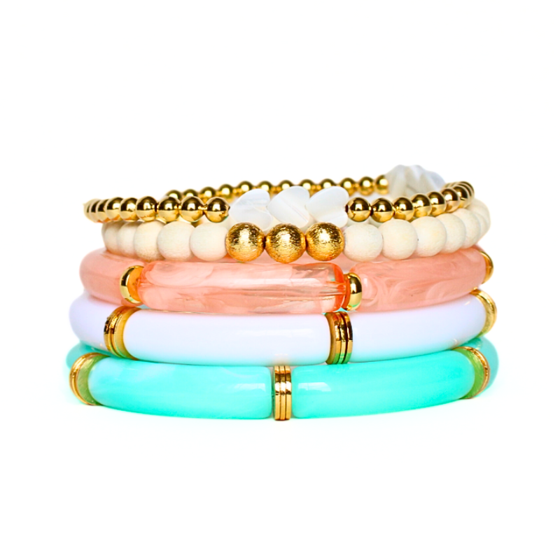5-piece bracelet set. Designed with a peach marble, white and aqua marble 8mm acrylic bamboo tubed bangle. Each acrylic bangle has gold plated flats alternating between each acrylic tube. This bracelet stack is also designed with a lightweight wooden white beaded stretch bracelet with brushed gold beads and a dainty 4mm gold filled beaded bracelet accented with pearl hearts.