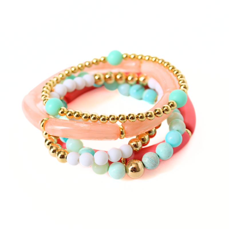5-peice beach inspired stack. Designed with blue opal gemstone beads with gold filled round beads. Two acrylic 8mm skinny tube bangles with gold plated flats. Acrylic tubes are peach marble and watermelon. The other two bracelets in this set are dainty and are adorned with gold filled round beads. 6mm blue acrylic beads and 5mm white acrylic beads accent the gold bracelets.