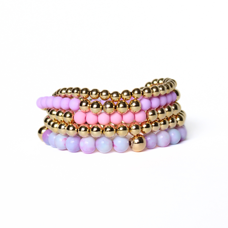 5-piece purple and pink feminine stack. Adorned with 6mm purple opal gemstone beads, pink and purple acrylic beads with 18k gold filled round beads.
