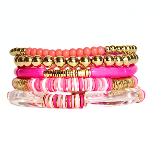Bright pink beaded bracelet stack featuring polymer clay, acrylic and gold beads.