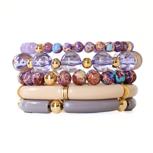 5-piece purple and cream stacking bracelet set. Designed with acrylic tube bangles, large purple acrylic beads.