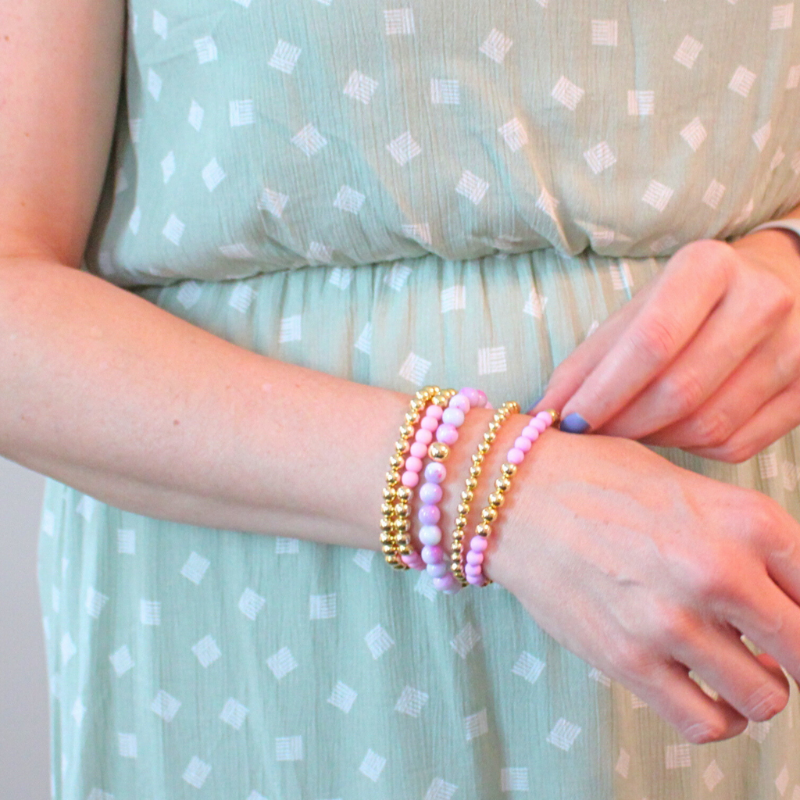 5-piece purple and pink feminine stack. Adorned with 6mm purple opal gemstone beads, pink and purple acrylic beads with 18k gold filled round beads.