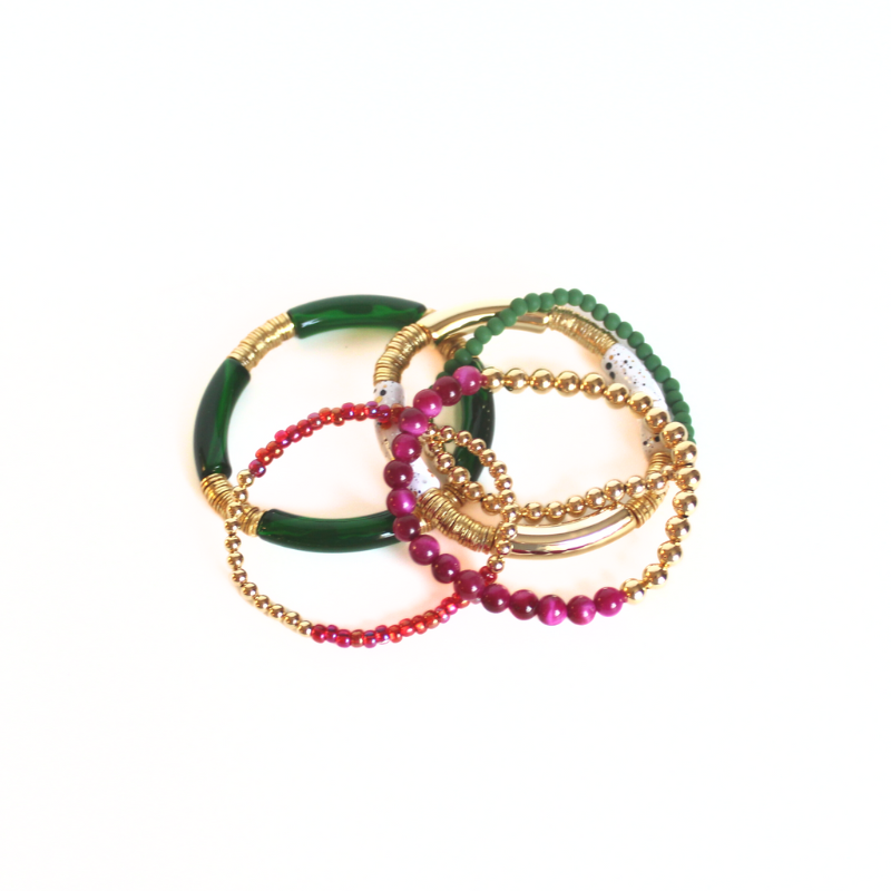 Red and green 5-piece 18K gold beaded stretch bracelet set designed with glass beads, red seed beads and natural fuchsia Tigers eye beads. Two bracelets are designed with white speckled and green acrylic bangles with gold flat beads.