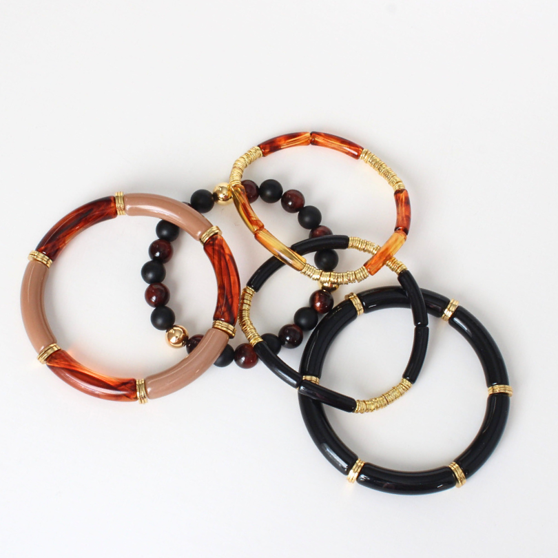 5-piece black and brown acrylic bracelet stack. Black and brown onyx and red's eye gemstone beaded bracelet with gold-filled round beads.