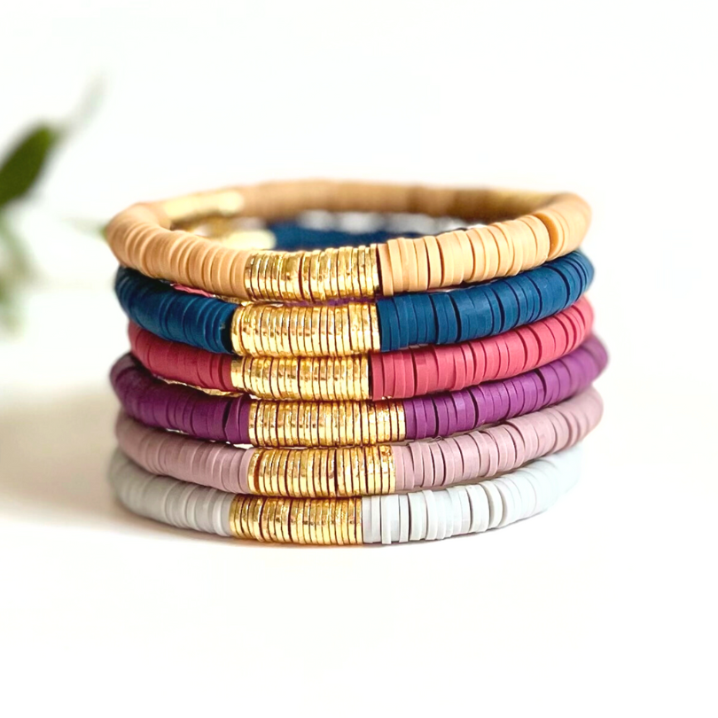 Single beaded neutral stretch bracelet for layering and stacking. Curated with navy blue polymer clay beads and gold-plated flat beads, this classic bracelet will add a timeless look to any outfit or bracelet stack. Wear alone or add to any bracelet to create the perfect look.