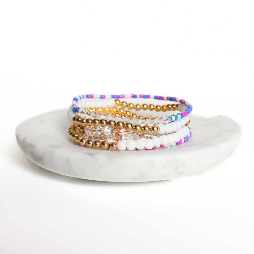Matching best friend bracelets; one for you and one for you best friend. These beaded bracelets are not our typical childhood best friend bracelets. These best friend bracelets are curated with 18k gold filled round beads, white glass beads, blue rainbow see beads and crystal beads. Each bracelet is uniquely designed with a "bestie" Morse code message using crystal beads.