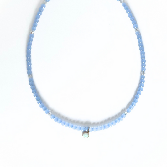 Blue glass beaded layering necklace with dainty round opal charm.