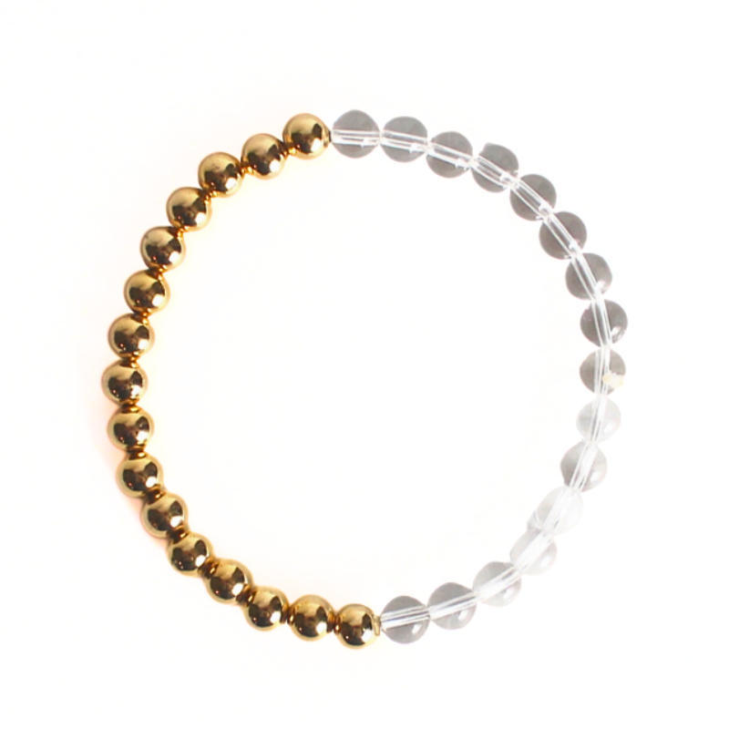 This duo beaded stretch bracelet is perfect to wear alone to add a little extra sparkle to your stack. Curated with gold filled round beads and clear round quartz beads.