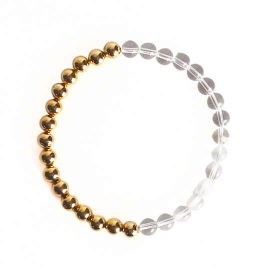 This duo beaded stretch bracelet is perfect to wear alone to add a little extra sparkle to your stack. Curated with gold filled round beads and clear round quartz beads.