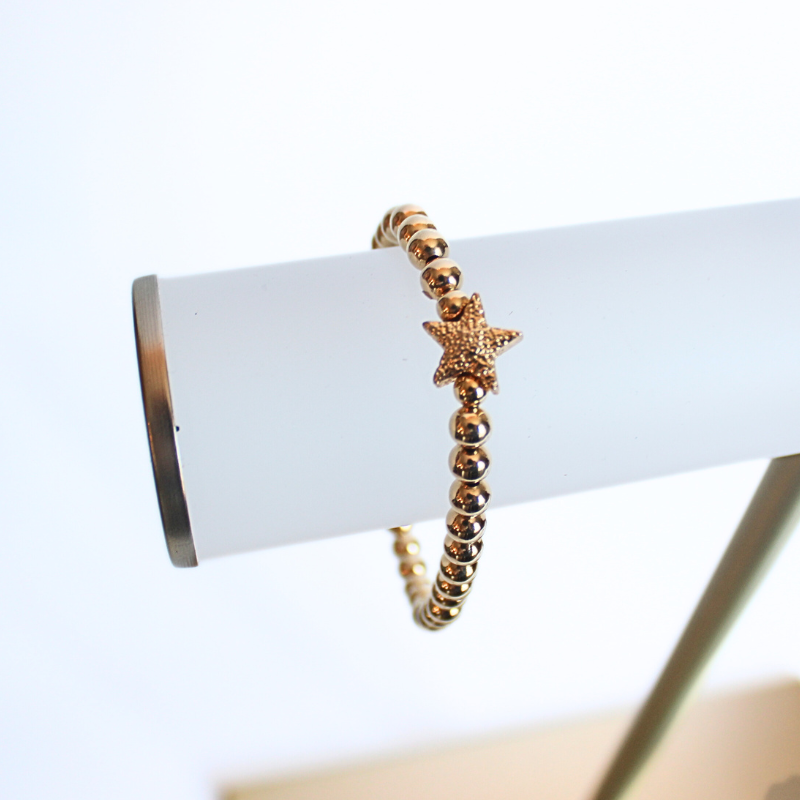 Dainty gold filled beaded stretch bracelet with gold plated forte star charm