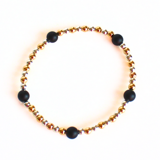 This delicate two-toned beaded bracelet is the perfect bracelet for everyday wear. With both gold filled and sterling silver tones, this bracelet can be worn with all of your bracelets. Also curated with black onyx gemstone beads.
