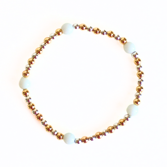 This delicate two-toned beaded bracelet is the perfect bracelet for everyday wear. With both gold filled and sterling silver tones, this bracelet can be worn with all of your bracelets. Also curated with white onyx gemstone beads.