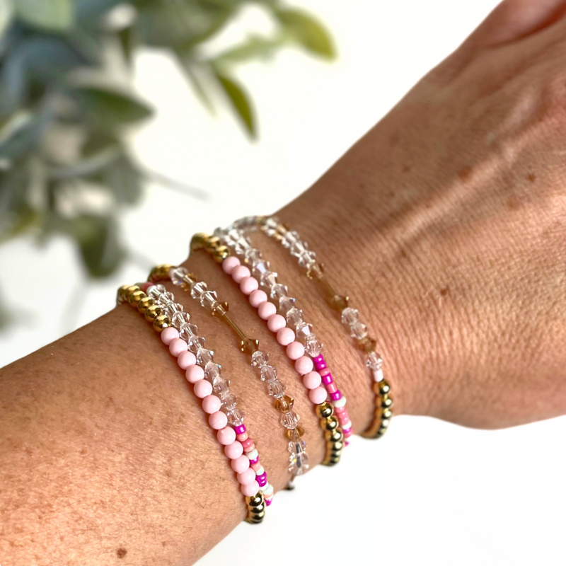Matching best friend bracelets; one for you and one for you best friend. These beaded bracelets are not our typical childhood best friend bracelets. These best friend bracelets are curated with 18k gold filled round beads, pink rainboe glass beads, and crystal beads. Each bracelet is uniquely designed with a "bestie" Morse code message using crystal beads.