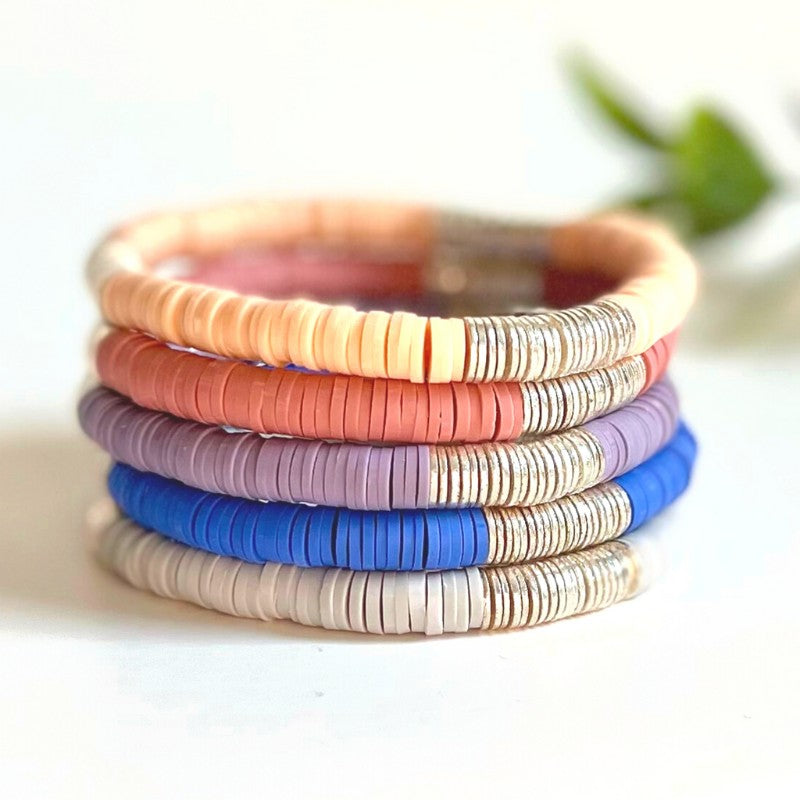 Single beaded neutral stretch bracelet for layering and stacking. Curated with blue polymer clay beads and silver-plated flat beads, this classic bracelet will add a timeless look to any outfit or bracelet stack. Wear alone or add to any bracelet to create the perfect look.