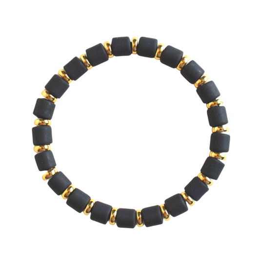 Single black beaded neutral stretch bracelet for layering and stacking. Curated with black wide polymer clay beads and gold-plated flat beads.