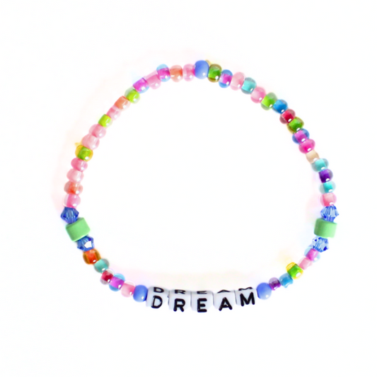 Dainty stretch word bracelet. Made with 5mm white with black letter cubed acrylic beads, 4mm blue and rainbows eed beads and green enamel cylinder beads. Letter beads can be personalized. Choose a name, initial or inspirational word to make it your own.