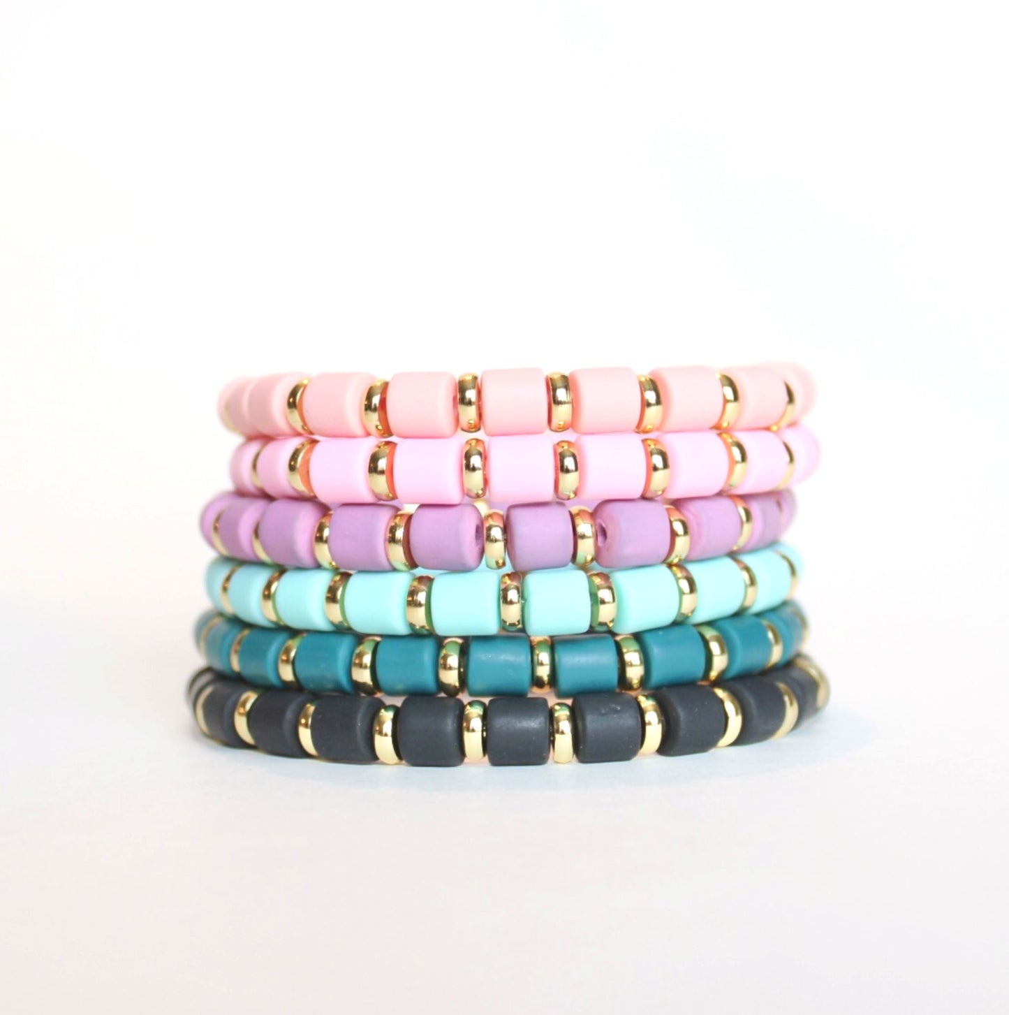 Single purple beaded bright retch bracelet for layering and stacking. Curated with purple wide polymer clay beads and gold-plated flat beads, this fun and bright bracelet will add a pop of color to any outfit or bracelet stack. Wear alone or add to any bracelet to create the perfect look.