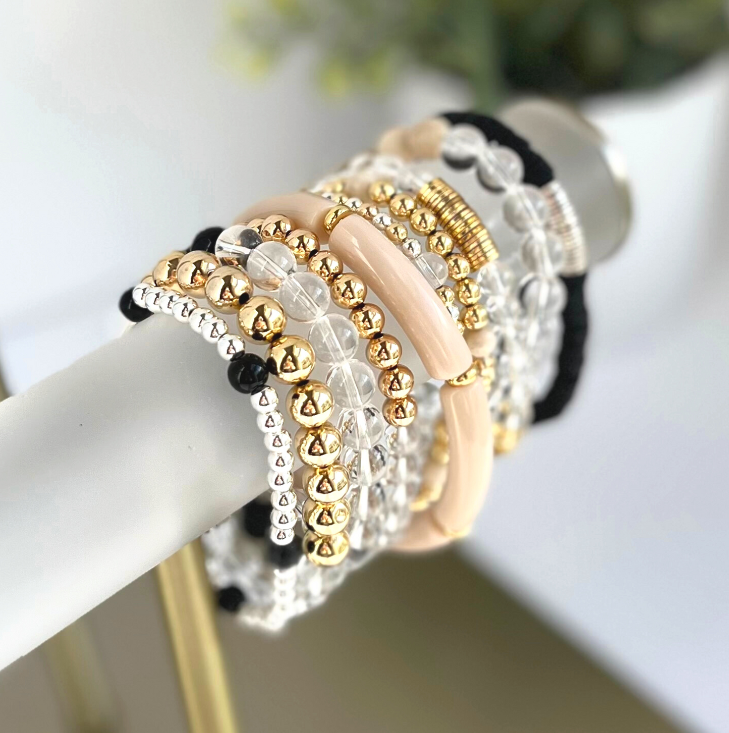 This delicate two-toned beaded bracelet is the perfect bracelet for everyday wear. With both gold filled and sterling silver tones, this bracelet can be worn with all of your bracelets. Also curated with white onyx gemstone beads.