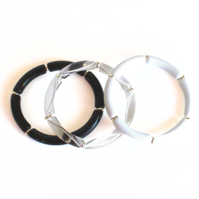 Black, white and clear acrylic bangle with silver beads. This lightweight bangle is versatile and will go with any bracelet in your jewelry box.