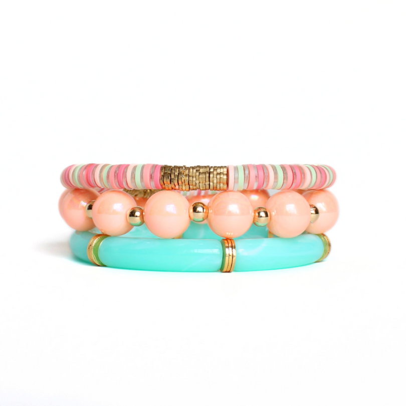 3-Piece chunky beaded bracelet stack. Designed with 12mm round peach iridescent beads and acrylic aqua marble tube bead bangle. 