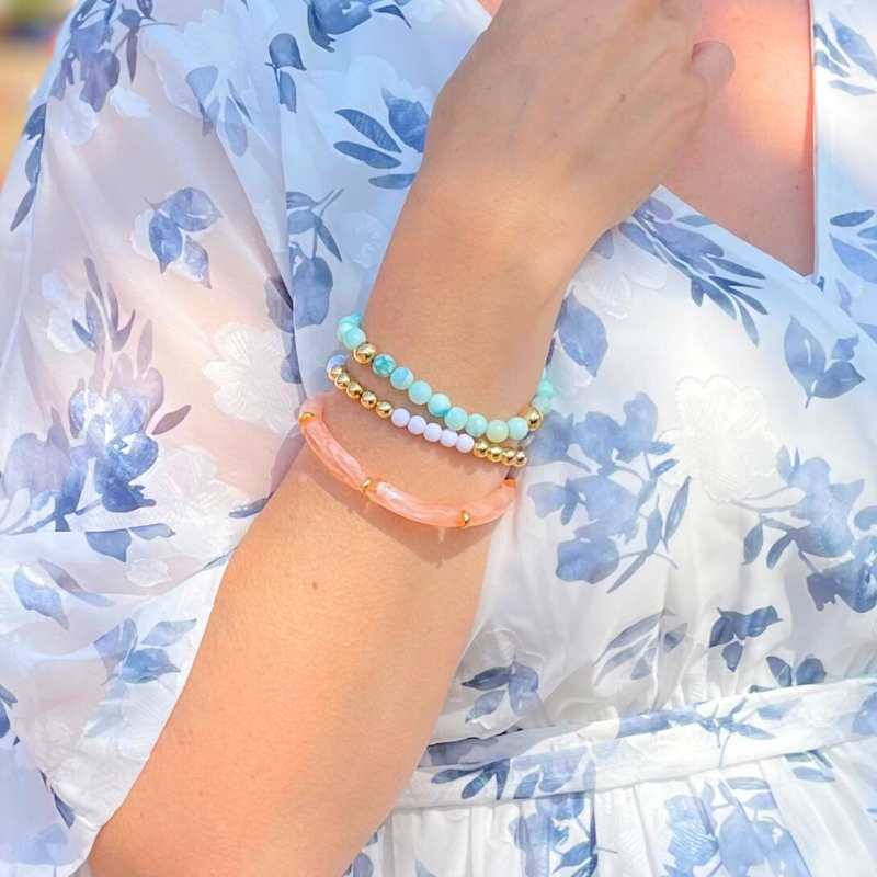 3-peice stacking bracelet set.  Blue opal beaded bracelet compliments a peach marble  acrylic bangle and a white and gold matte acrylic bracelet