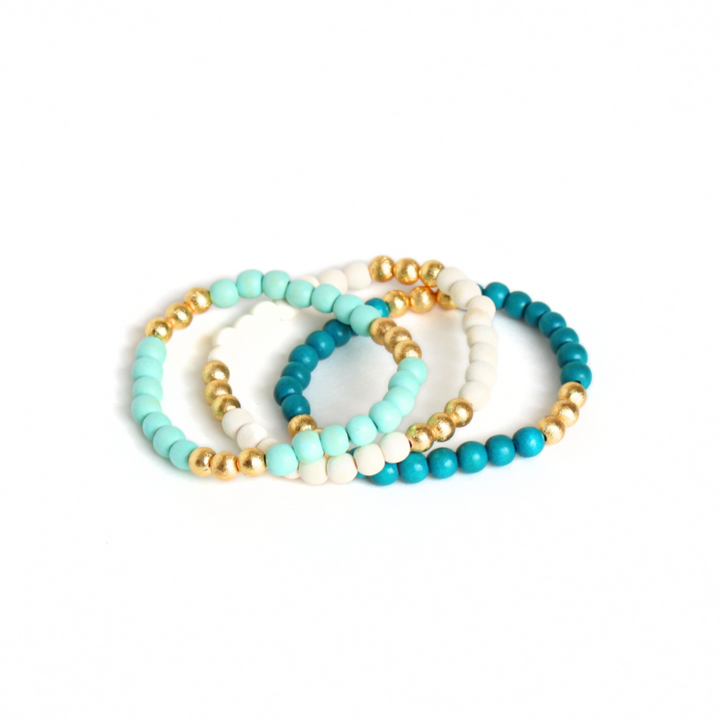 3-peice turquoise, mint and white lightweight wood stretch beaded bracelet set. All three bracelets accented with brushed gold beads.
