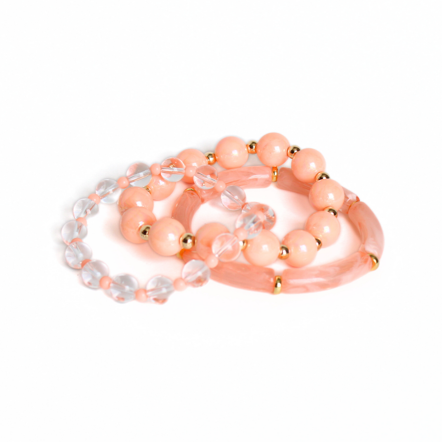 3-peice peach golden hour beach bracelet set. Designed with 8mm skinny acrylic bamboo tubes with alternating gold flats. Chunky 12mm peach iridedescent acrylic beads with alternating 5mm gold beads. 6mm clear quartz round beads with alternating 4mm peach acrylic beads.