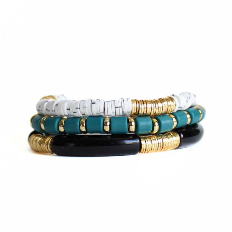 3-piece green and black bracelet stack. Designed with dark green wide polymer clay beads and wide gold spacers. This stack also is designed with black acrylic beads and white with gray polymer clay.